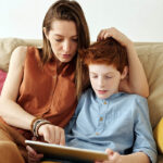 mother helping child with reading